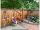 Relaxing patio area with a water feature, stone pavers, and a privacy fence adorned with art at 1038 E 4Th Ave, Denver, CO 80218