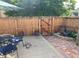 Outdoor patio space with dining set, stone pavers, garden accents, and a lounging cat at 1038 E 4Th Ave, Denver, CO 80218