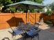 Outdoor patio dining area featuring a metal table, four chairs, an umbrella, and a soothing Buddha statue at 1038 E 4Th Ave, Denver, CO 80218