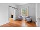 Comfortable sitting room with hardwood floors, a large window, and a decorative fireplace at 1038 E 4Th Ave, Denver, CO 80218