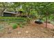 Landscaped backyard featuring a patio with seating and lush greenery at 116 Monarch St, Louisville, CO 80027