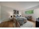 Well-lit bedroom with hardwood floors, a large window, and stylish decor at 116 Monarch St, Louisville, CO 80027