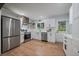 Modern kitchen features stainless steel appliances, white cabinetry, and ample counter space at 116 Monarch St, Louisville, CO 80027