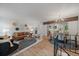 Bright living room featuring a modern design, hardwood floors, and seamless flow into the adjacent kitchen at 116 Monarch St, Louisville, CO 80027