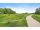 Picturesque walking path through a lush green field, ideal for outdoor activities and nature walks at 116 Monarch St, Louisville, CO 80027