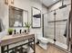 Modern bathroom featuring a walk-in shower, floating vanity, and stylish decorative art at 6736 S Flanders Ct, Aurora, CO 80016