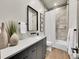Elegant bathroom featuring modern fixtures, neutral tiling, and a combined tub and shower at 6736 S Flanders Ct, Aurora, CO 80016