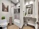 Clean bathroom with a tub/shower combo, a gray vanity, and a decorative print on the wall at 6736 S Flanders Ct, Aurora, CO 80016