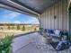 Inviting covered patio with outdoor seating, string lights, and stunning views of the surrounding landscape at 6736 S Flanders Ct, Aurora, CO 80016