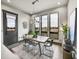 Elegant dining room with large windows, stylish lighting, and views of the outdoors at 6736 S Flanders Ct, Aurora, CO 80016