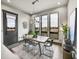 Modern dining room with large windows, a stylish table, and view at 6736 S Flanders Ct, Aurora, CO 80016