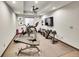 Well-lit home gym featuring treadmill, stationary bike and weight training equipment at 6736 S Flanders Ct, Aurora, CO 80016
