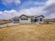 Beautiful single Gathering home with a stone and blue painted facade, nice yard and three car garage at 6736 S Flanders Ct, Aurora, CO 80016