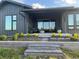 Beautiful home exterior with stone accents, a covered patio, and landscaped garden beds at 6736 S Flanders Ct, Aurora, CO 80016
