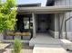 Inviting front porch with decorative planters and stylish gray trim at 6736 S Flanders Ct, Aurora, CO 80016