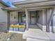 Inviting front porch with stone accents, wood facade, and space for sitting at 6736 S Flanders Ct, Aurora, CO 80016