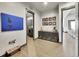 Hallway featuring a laundry room, decorative art, and stylish decor at 6736 S Flanders Ct, Aurora, CO 80016