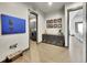 Hallway featuring stylish decor and art, seamlessly connecting the laundry area and living space at 6736 S Flanders Ct, Aurora, CO 80016