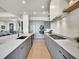 Modern kitchen featuring stainless steel appliances, sleek gray cabinetry, and expansive countertops at 6736 S Flanders Ct, Aurora, CO 80016