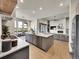 Open-concept kitchen boasts a large island, stainless steel appliances, and views of the living area at 6736 S Flanders Ct, Aurora, CO 80016