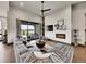 Spacious living room with a cozy fireplace and large sliding glass doors for natural light at 6736 S Flanders Ct, Aurora, CO 80016