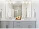 Double vanity bathroom with modern fixtures and bright lighting at 3109 W Bates Ave, Denver, CO 80236