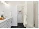 Modern bathroom with double vanity, large mirror, and walk-in shower at 3109 W Bates Ave, Denver, CO 80236