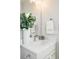 Clean bathroom with a single vanity and white cabinets at 3109 W Bates Ave, Denver, CO 80236