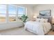 Main bedroom with large windows, plush bed, and stylish decor at 3109 W Bates Ave, Denver, CO 80236