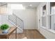 Spacious entryway with hardwood floors and modern staircase at 3109 W Bates Ave, Denver, CO 80236