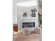 Modern fireplace with white hexagon tile surround and floating mantel at 3109 W Bates Ave, Denver, CO 80236