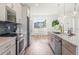 Open concept kitchen with island and hardwood floors at 3109 W Bates Ave, Denver, CO 80236