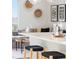 Kitchen island with seating and view into living room at 3109 W Bates Ave, Denver, CO 80236