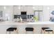 Modern kitchen with white cabinetry, quartz countertops, and stylish lighting at 3109 W Bates Ave, Denver, CO 80236