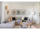 Spacious living room with sectional sofa, coffee table, and decorative wall art at 3109 W Bates Ave, Denver, CO 80236