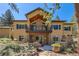 Beautiful back of house featuring a balcony, stone accents, and manicured garden at 731 Weston Rd, Larkspur, CO 80118