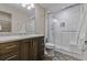 Modern bathroom featuring a walk-in shower with white subway tiles, a wooden vanity and patterned flooring at 731 Weston Rd, Larkspur, CO 80118