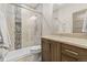 Beautiful bathroom with a glass-enclosed shower featuring stylish tile work, a wooden vanity and marble countertops at 731 Weston Rd, Larkspur, CO 80118