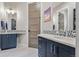 Bathroom featuring dual sinks, decorative mirrors, and mosaic tile backsplash at 731 Weston Rd, Larkspur, CO 80118