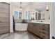 Modern bathroom features a soaking tub beneath windows and custom wood cabinetry at 731 Weston Rd, Larkspur, CO 80118