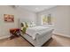 Serene bedroom featuring a tufted gray bed frame, soft bedding, and a bright window with forest views at 731 Weston Rd, Larkspur, CO 80118