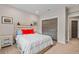 Comfortable bedroom featuring a wooden bed frame, a plush white comforter and gray sliding closet doors at 731 Weston Rd, Larkspur, CO 80118