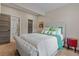 Cozy bedroom with tufted gray bed frame, soft bedding, and an attached bathroom at 731 Weston Rd, Larkspur, CO 80118