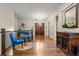 Foyer with hardwood floors, ornate table, and chairs beneath a modern chandelier at 731 Weston Rd, Larkspur, CO 80118