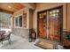 Charming front porch featuring stone accents, wood ceiling, and a stylish double door at 731 Weston Rd, Larkspur, CO 80118