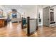 Hallway featuring hardwood floors, staircase, and view to the living room with fireplace at 731 Weston Rd, Larkspur, CO 80118