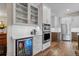 Kitchen featuring white cabinets, beverage cooler, and stainless steel appliances at 731 Weston Rd, Larkspur, CO 80118