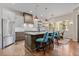 Kitchen with an island, seating, stainless steel appliances, and hardwood floors at 731 Weston Rd, Larkspur, CO 80118