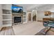 Spacious living area with a stone fireplace, built-in shelving, and access to stairs and the kitchen at 731 Weston Rd, Larkspur, CO 80118