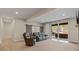 Bright living room with sliding glass doors to patio, stylish barn doors and comfortable leather seating at 731 Weston Rd, Larkspur, CO 80118